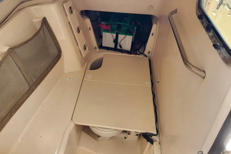 Slide: The Image of Interior of 2012 Grady-White Freedom 307 boat, featuring storage and battery compartment. - 23