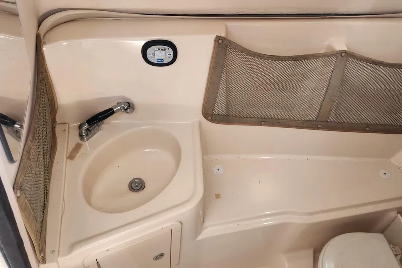 Slide: The Image of Interior of 2012 Grady-White Freedom 307 boat with sink and storage netting. - 25