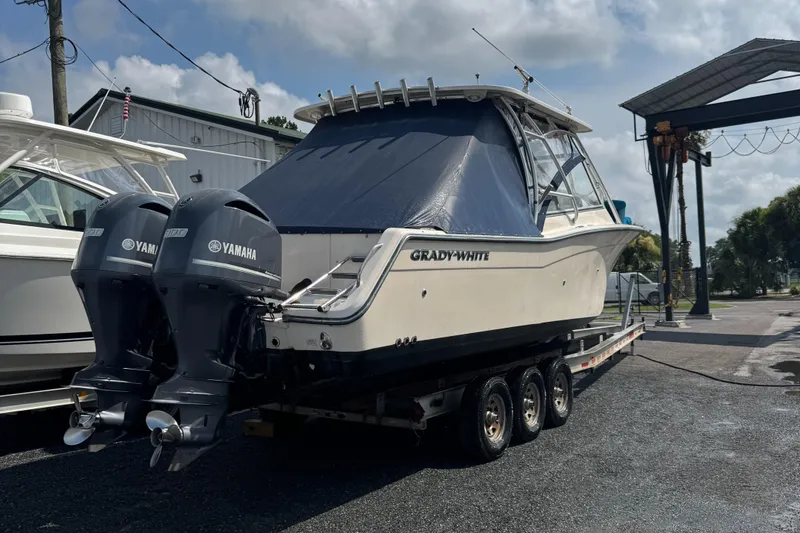 Slide: The Image of 2012 Grady-White Freedom 307 boat with dual Yamaha engines on a trailer. - 32