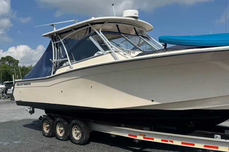 Slide: The Image of 2012 Grady-White Freedom 307 boat on trailer under blue sky. - 33