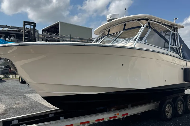 Slide: The Image of 2012 Grady-White Freedom 307 boat on trailer under cloudy sky. - 34