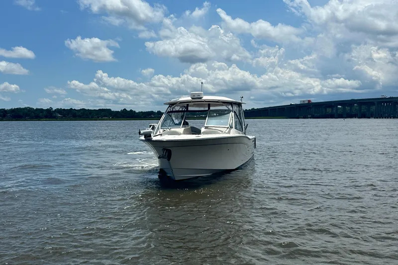Slide: The Image of 2012 Grady-White Freedom 307 boat on calm water under a partly cloudy sky. - 4