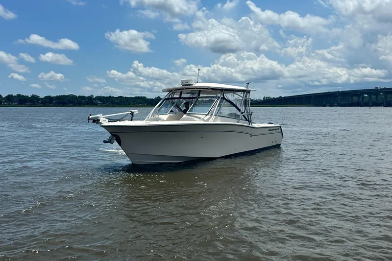 Slide: The Image of 2012 Grady-White Freedom 307 boat on calm water under a partly cloudy sky. - 5