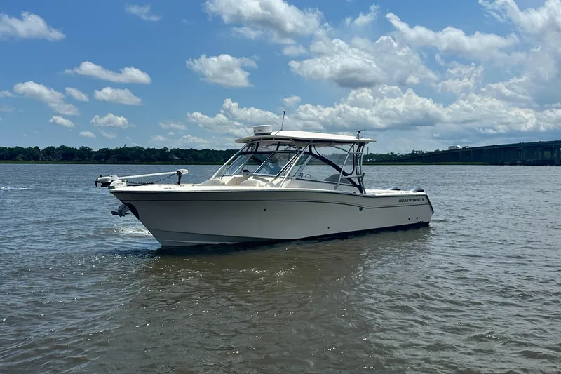 Slide: The Image of 2012 Grady-White Freedom 307 boat on calm water under a partly cloudy sky. - 6