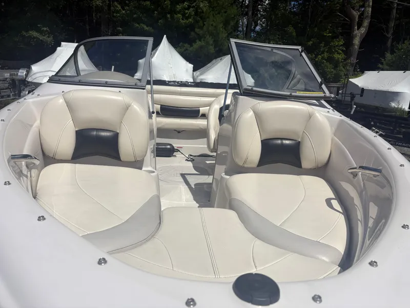 Slide: The Image of 2012 Tahoe Q5i boat interior with white leather seats and open windshield. - 4