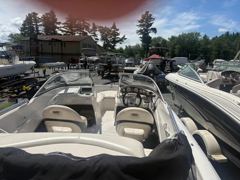 Slide: The Image of 2012 Tahoe Q5i boat in a marina, surrounded by other boats and trailers. - 5