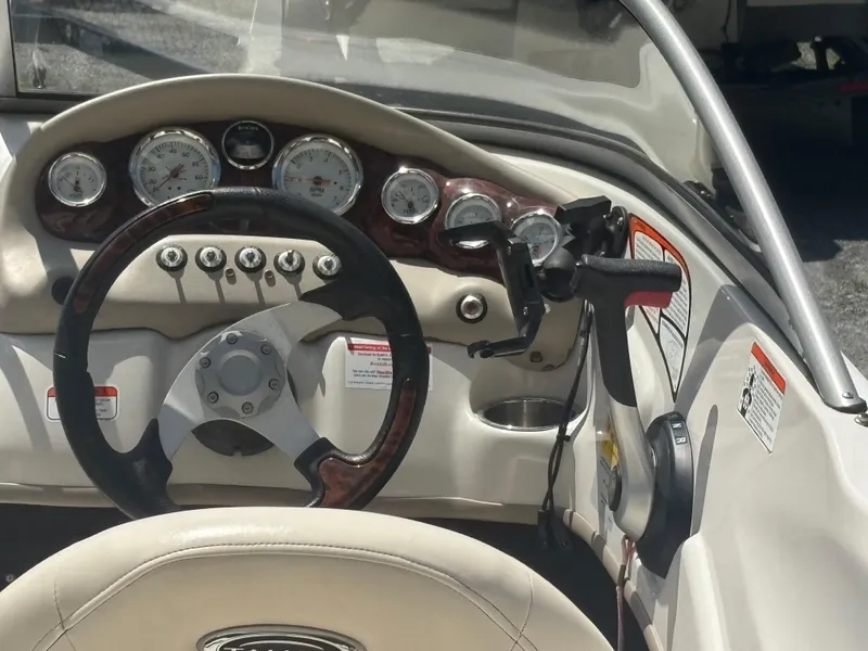 Slide: The Image of 2012 Tahoe Q5i boat dashboard with steering wheel and control panel. - 6