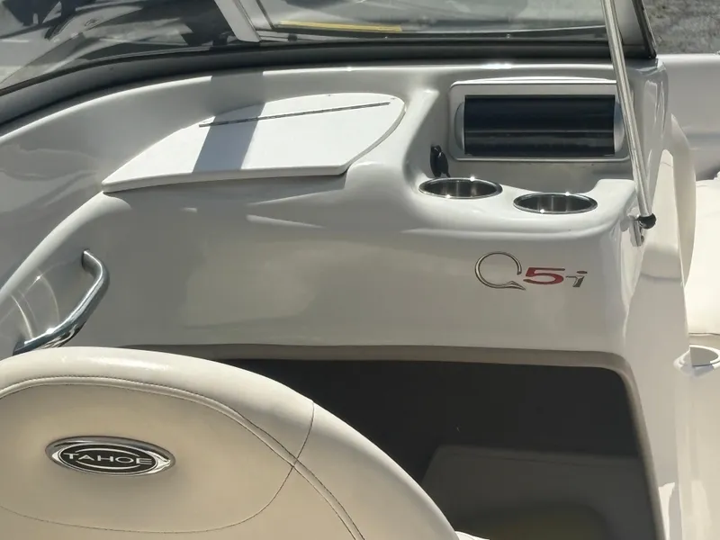 Slide: The Image of Interior of 2012 Tahoe Q5i boat with cup holders and dashboard. - 7