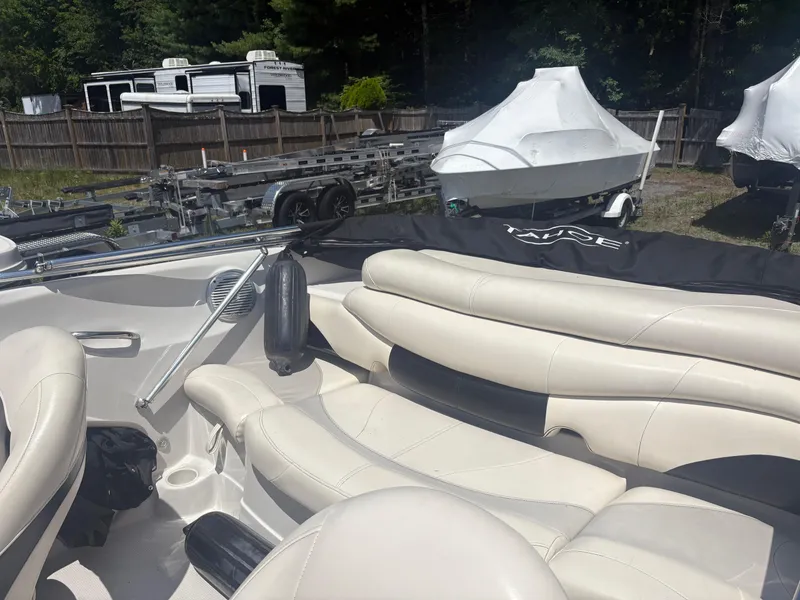 Slide: The Image of Interior of a 2012 Tahoe Q5i boat with white leather seating and outdoor storage area. - 8