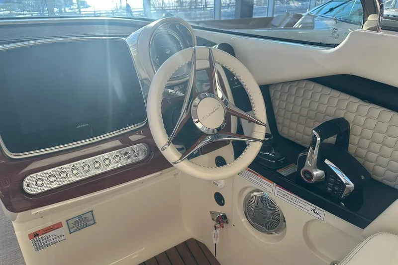 Slide: The Image of 2026 Chris-Craft Launch 31 GT helm with steering wheel, controls, and display. - 19