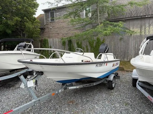 Slide: The Image of 2006 Boston Whaler 130 Sport boat on trailer, parked outdoors. - 5
