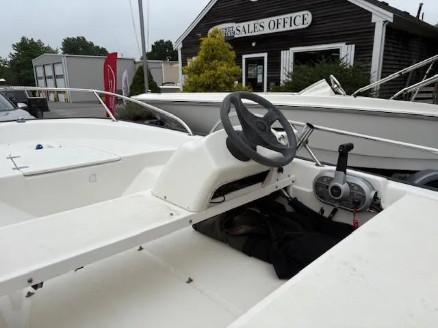 Slide: The Image of 2006 Boston Whaler 130 Sport boat interior with steering wheel, near sales office. - 6