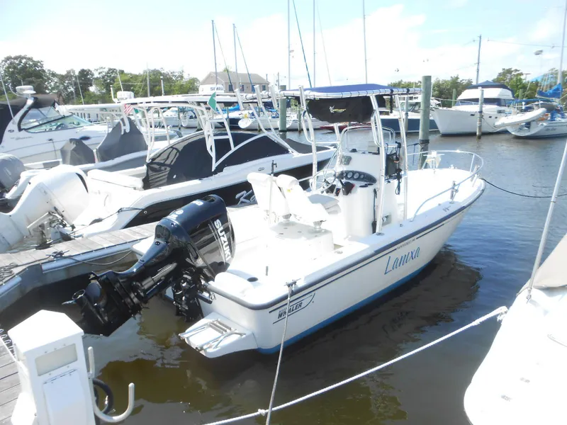 Slide: The Image of 2003 Boston Whaler 190 Nantucket boat docked in marina with Suzuki outboard motor. - 1