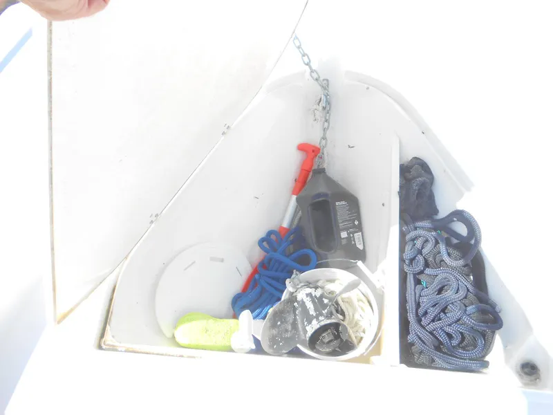 Slide: The Image of Storage compartment of 2003 Boston Whaler 190 Nantucket with ropes and boating equipment. - 10