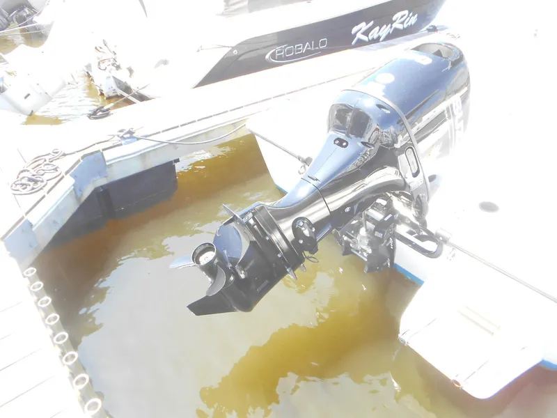 Slide: The Image of Outboard motor on a 2003 Boston Whaler 190 Nantucket at a dock. - 2