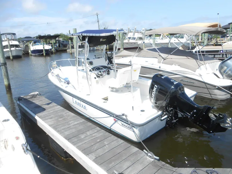 Slide: The Image of 2003 Boston Whaler 190 Nantucket boat docked with Suzuki outboard motor. - 3