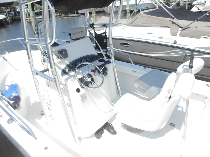 Slide: The Image of 2003 Boston Whaler 190 Nantucket boat interior with steering wheel and seating. - 4