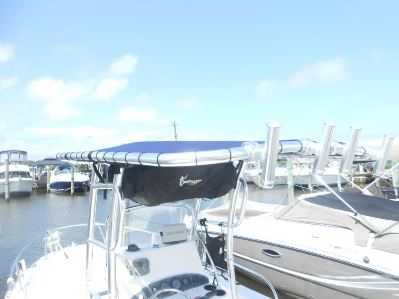 Slide: The Image of 2003 Boston Whaler 190 Nantucket boat docked with canopy and rod holders. - 5