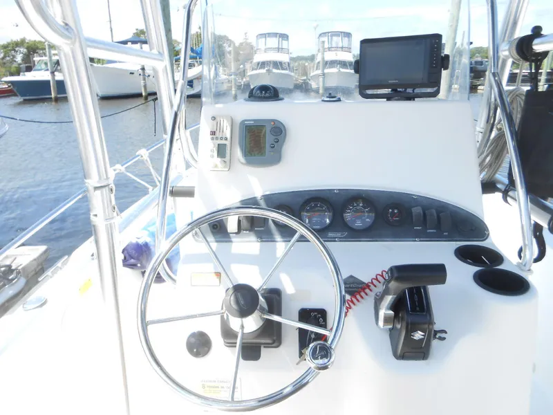 Slide: The Image of 2003 Boston Whaler 190 Nantucket boat console with steering wheel and navigation instruments. - 6