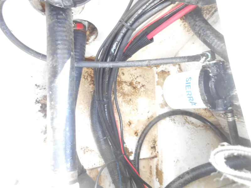 Slide: The Image of Engine compartment of a 2003 Boston Whaler 190 Nantucket with visible wiring and filter. - 9