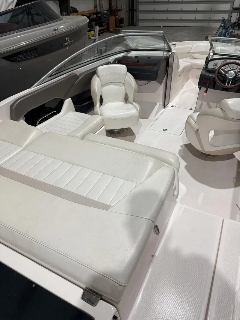Slide: The Image of 2008 Regal 2000 Bowrider boat interior with white seating and steering wheel. - 14
