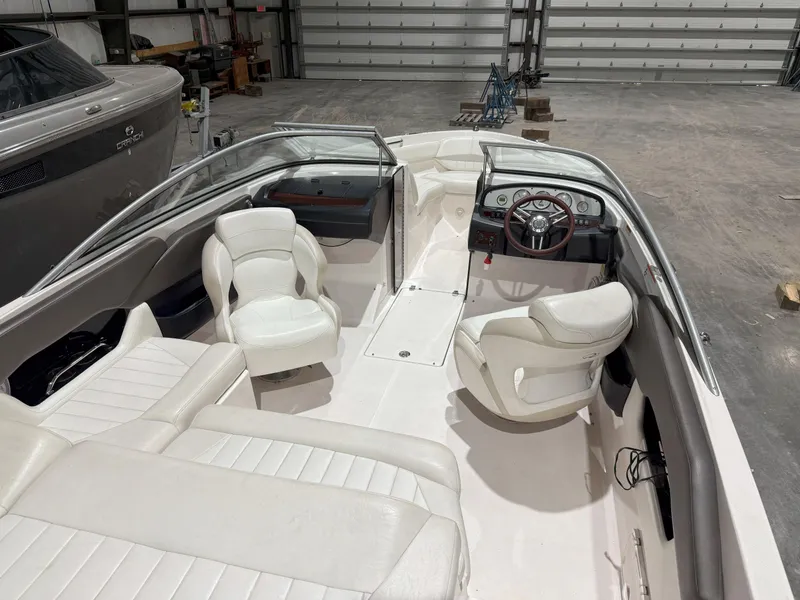 Slide: The Image of 2008 Regal 2000 Bowrider interior with white seating and steering wheel in a garage setting. - 16