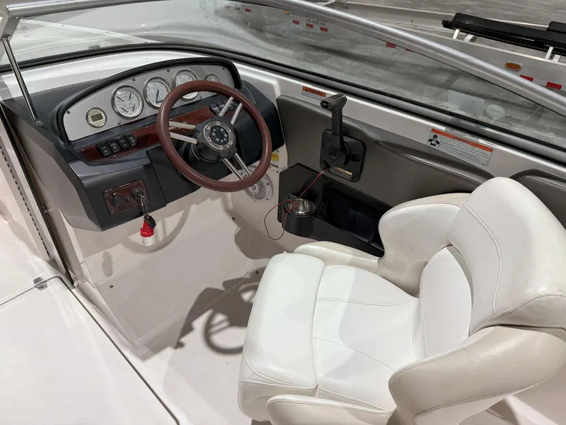 Slide: The Image of 2008 Regal 2000 Bowrider cockpit with steering wheel, gauges, and white captain's chair. - 18