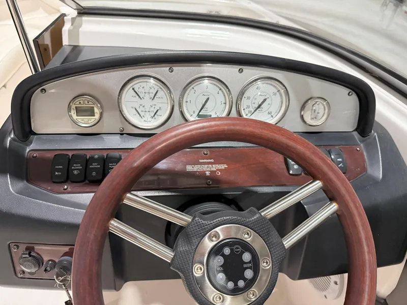 Slide: The Image of 2008 Regal 2000 Bowrider dashboard with gauges and wooden steering wheel. - 19