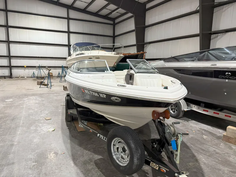 Slide: The Image of 2008 Regal 2000 Bowrider boat on trailer in indoor storage facility. - 2
