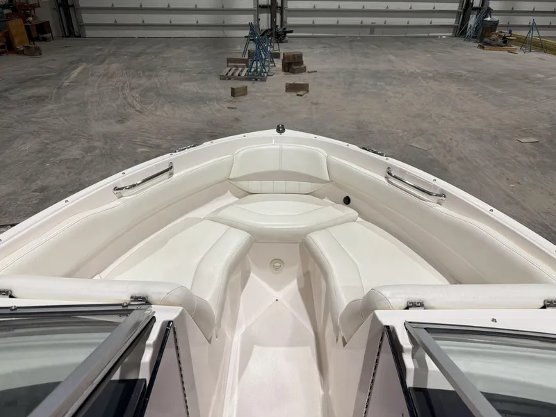 Slide: The Image of 2008 Regal 2000 Bowrider boat interior with white seating in a spacious warehouse. - 20