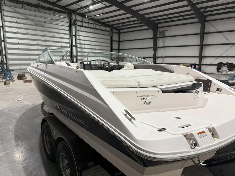 Slide: The Image of 2008 Regal 2000 Bowrider boat in a spacious indoor storage facility. - 4