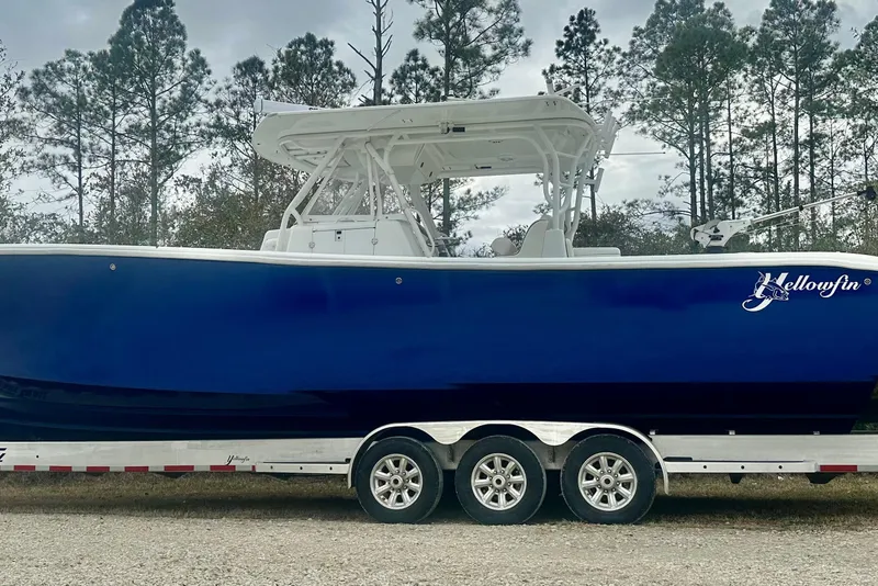 The Image of 2013 Yellowfin 39 Offshore boat on trailer, parked outdoors with trees in background. - 0