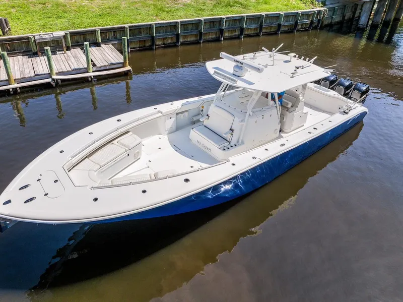 Slide: The Image of 2015 Yellowfin 39 boat with quad Mercury engines docked in a canal. - 15