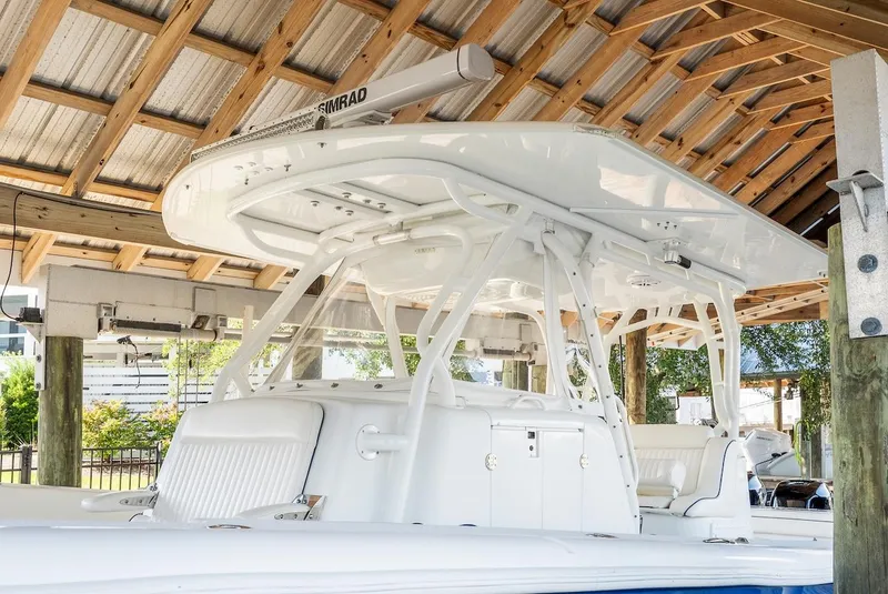 Slide: The Image of 2015 Yellowfin 39 boat docked under a wooden shelter. - 19