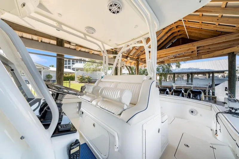 Slide: The Image of 2015 Yellowfin 39 boat under wooden canopy, showcasing spacious seating and storage. - 33
