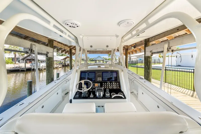 Slide: The Image of 2015 Yellowfin 39 boat interior with modern helm and seating under a wooden canopy. - 35