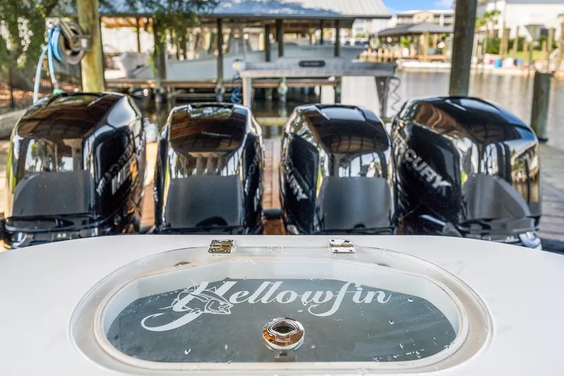 Slide: The Image of 2015 Yellowfin 39 boat cockpit with advanced navigation controls, docked under a wooden shelter. - 37