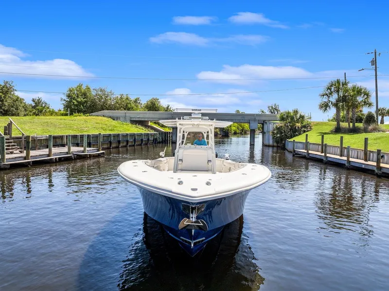 Slide: The Image of 2015 Yellowfin 39 boat docked, featuring a sleek blue hull and spacious deck. - 4