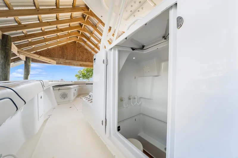 Slide: The Image of Interior of 2015 Yellowfin 39 boat featuring a compact marine toilet and wooden steps. - 40