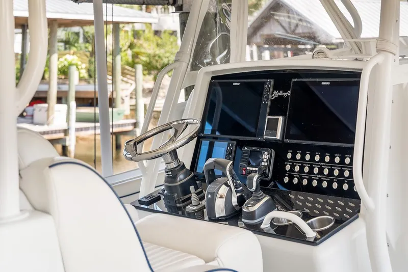 Slide: The Image of 2015 Yellowfin 39 boat interior with seating and storage, docked at a marina. - 47