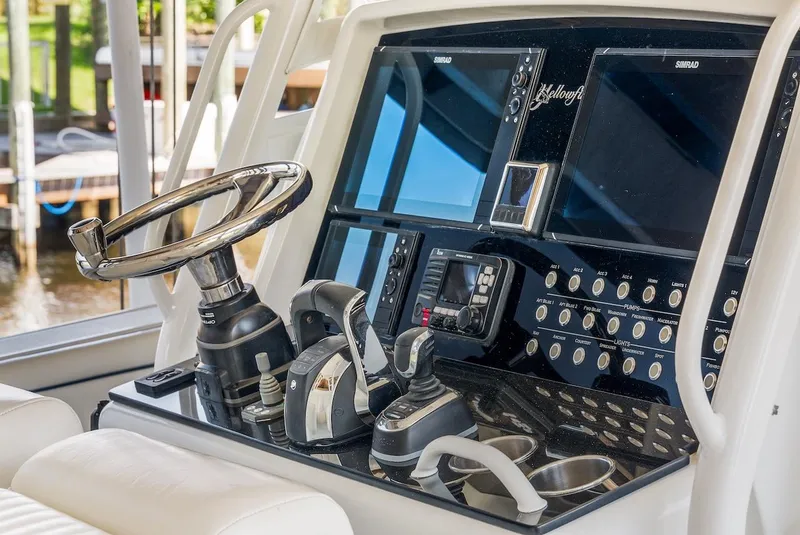 Slide: The Image of 2015 Yellowfin 39 boat helm with dual screens and control panel. - 48