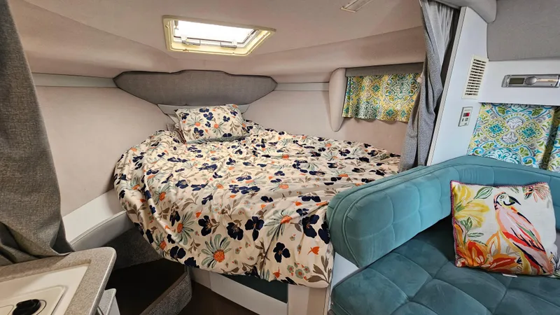 Slide: The Image of Cozy interior of a 1994 Formula 31 PC boat with floral bedding and colorful decor. - 15