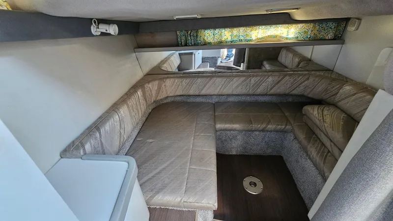 Slide: The Image of 1994 Formula 31 PC cabin interior with beige seating and patterned curtains. - 18