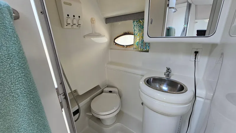 Slide: The Image of 1994 Formula 31 PC boat bathroom with sink, toilet, and mirror. - 19