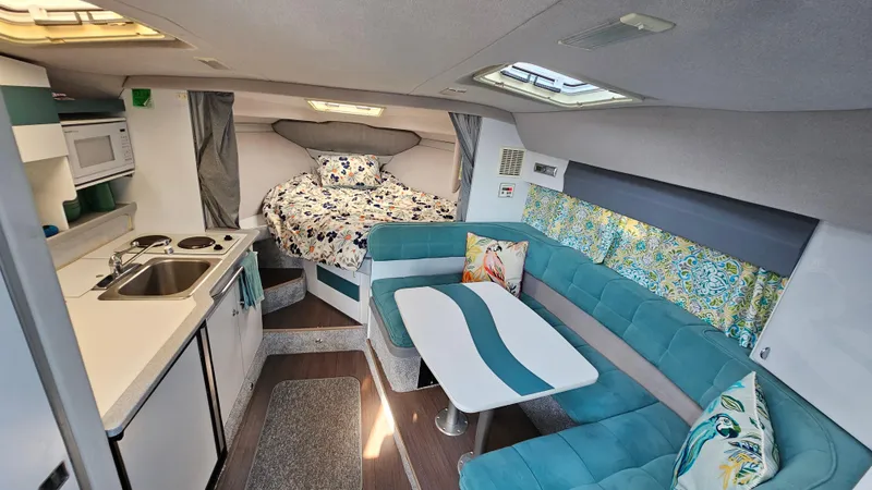 Slide: The Image of 1994 Formula 31 PC boat interior with kitchen, seating, and bed. - 20