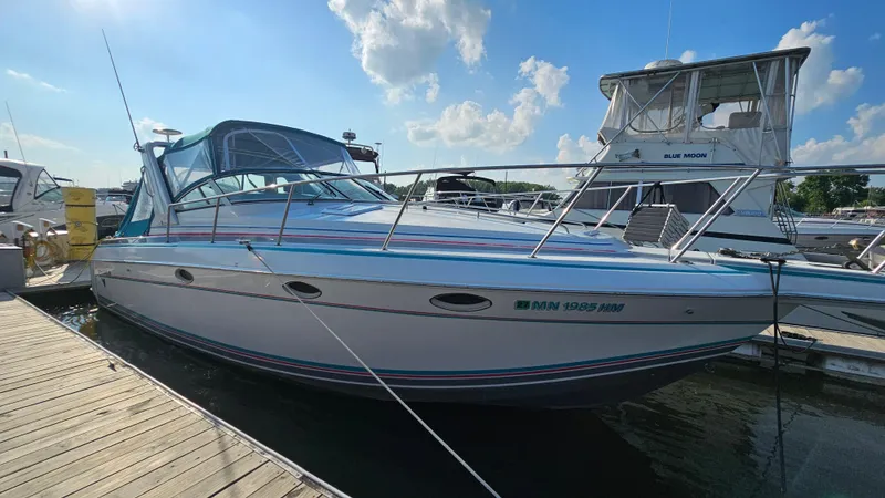 Slide: The Image of 1994 Formula 31 PC boat docked at marina under blue sky. - 3