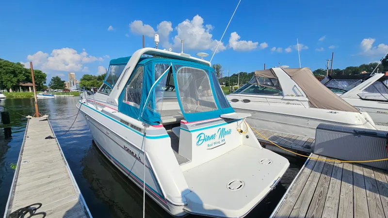 Slide: The Image of 1994 Formula 31 PC boat docked at marina under clear blue sky. - 4