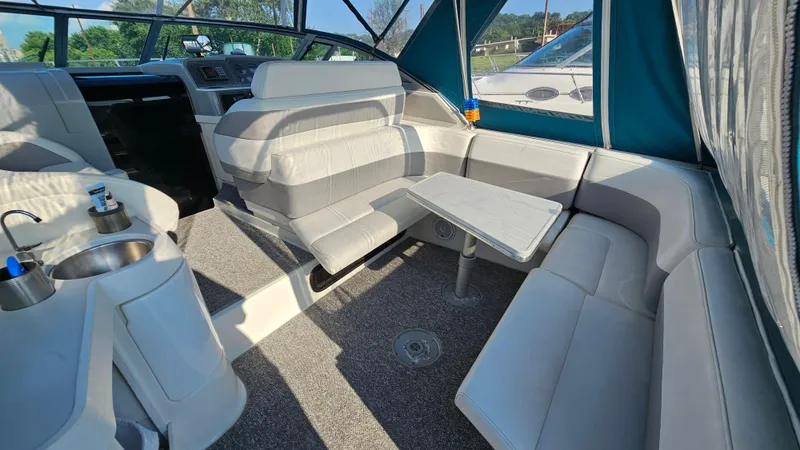 Slide: The Image of 1994 Formula 31 PC boat interior with seating, table, and kitchenette. - 5