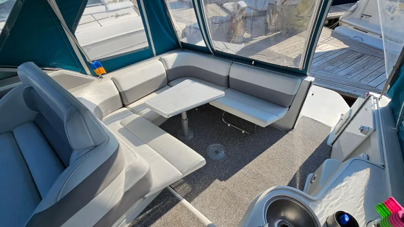 Slide: The Image of 1994 Formula 31 PC boat interior with seating and table, docked at marina. - 6
