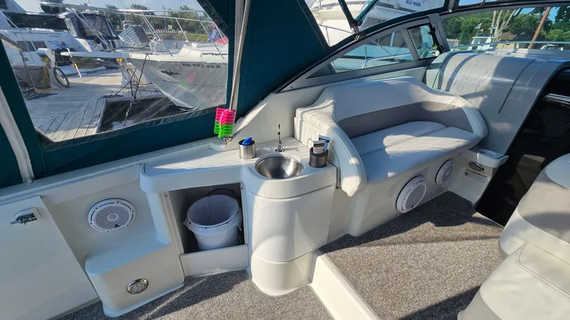 Slide: The Image of 1994 Formula 31 PC boat interior with seating, sink, and speakers at a marina. - 7